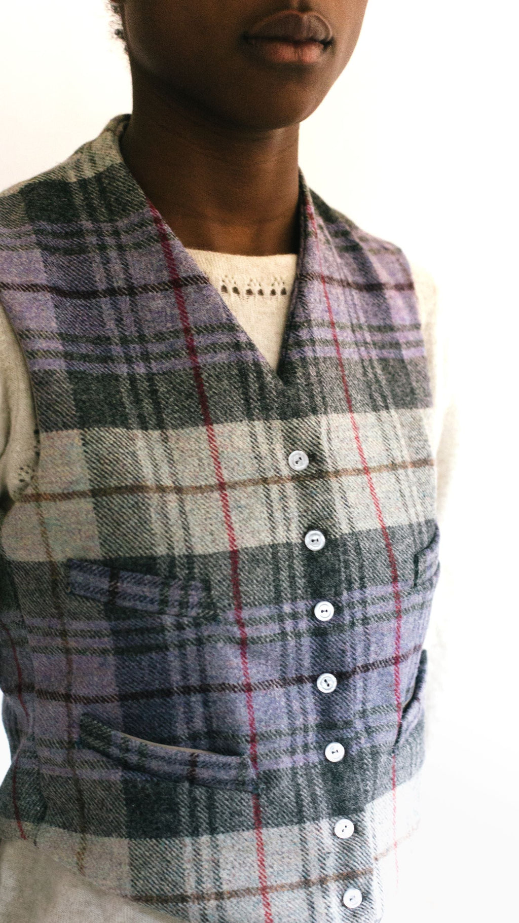 Close up of African woman wearing View C 222 Vintage Vests, collarless and four welts pockets